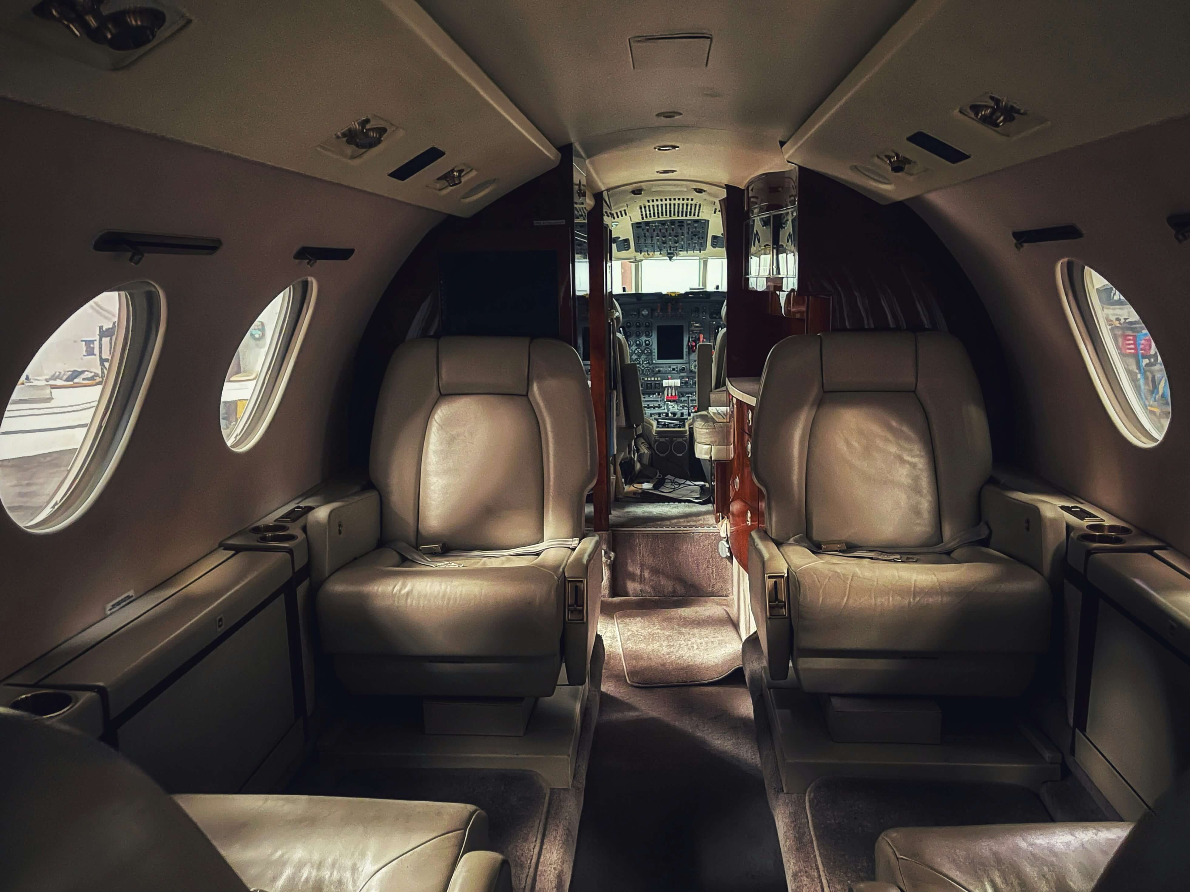 Luxury private jet interior with silk-lined seats and modern amenities